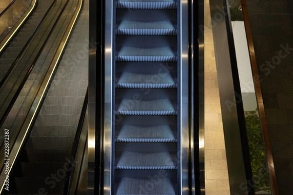 Fototapeta Illuminated escalator in a shopping mall