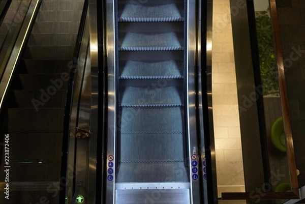 Fototapeta Illuminated escalator in a shopping mall