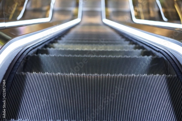 Fototapeta Illuminated escalator in a shopping mall