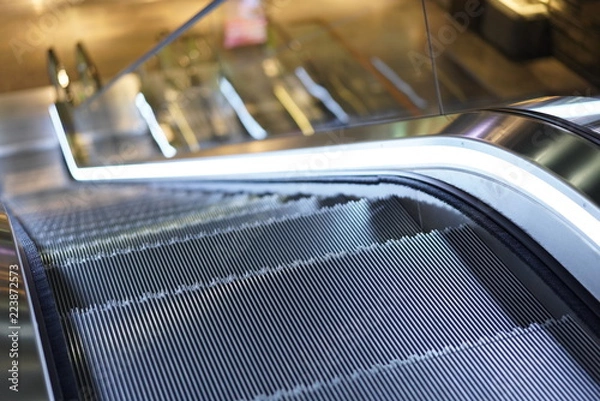 Fototapeta Illuminated escalator in a shopping mall