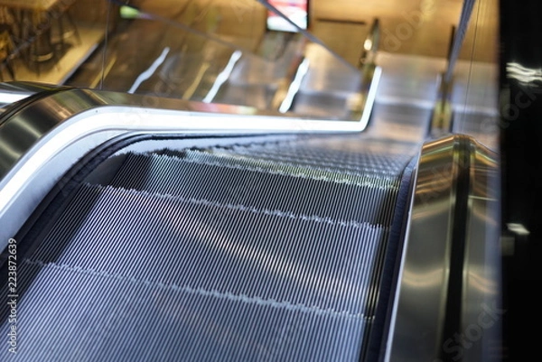 Fototapeta Illuminated escalator in a shopping mall