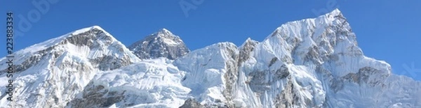 Fototapeta Amazing Shot Panoramic view of Nepalese Himalayas mountain peaks covered with white snow attract many climbers, some of them highly experienced mountaineers