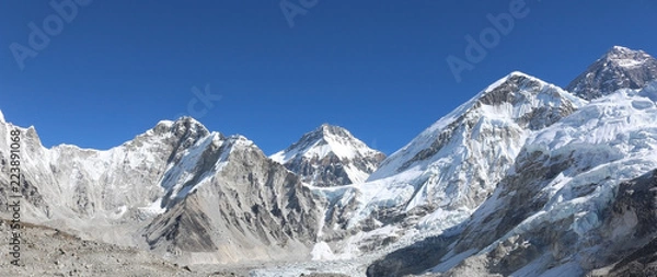 Fototapeta Amazing Shot Panoramic view of Nepalese Himalayas mountain peaks covered with white snow attract many climbers, some of them highly experienced mountaineers