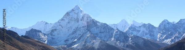 Fototapeta Amazing Shot Panoramic view of Nepalese Himalayas mountain peaks covered with white snow attract many climbers, some of them highly experienced mountaineers