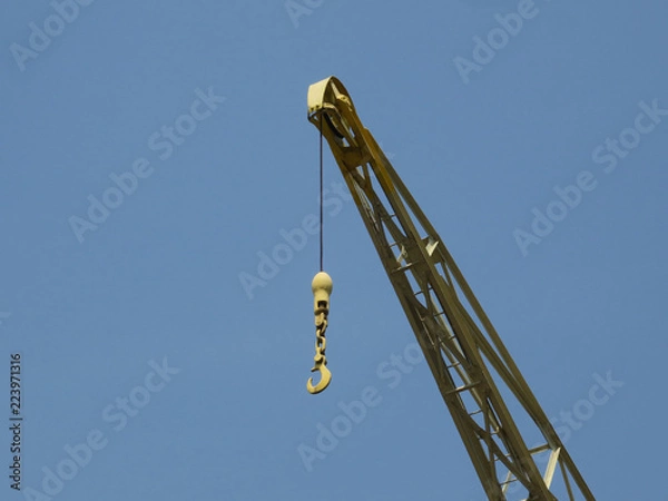 Fototapeta hook of a yellow crane in the harbor of Antwerp