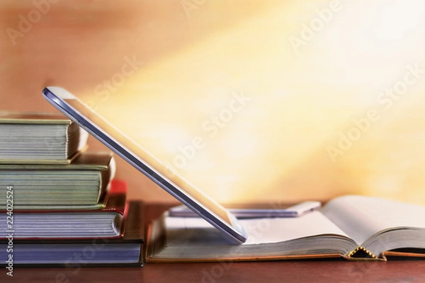Obraz Open textbook and notepad on the table.
