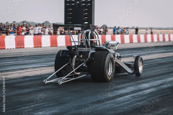 Obraz Dragster sets off on the racetrack. Dragster on the speedway. Drag wheel, torque, power, engine power.