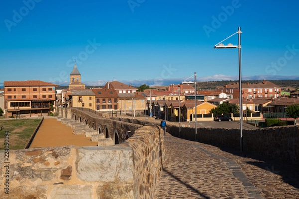 Fototapeta CAMINO DE SANTIAGO, SPAIN - AUGUST 8, 2018 - Some pilgrims walking along the way of St.James, in Hospital de Orbigo