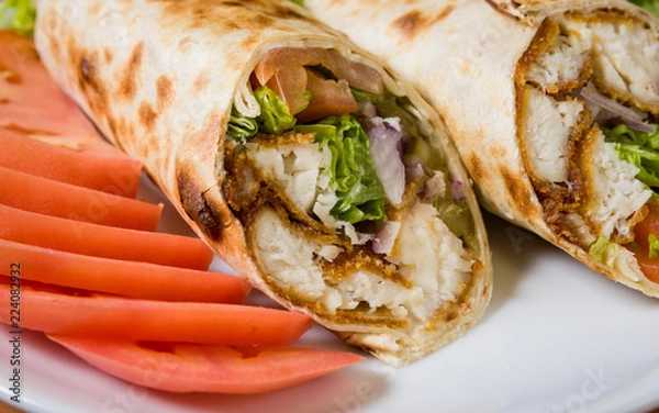 Fototapeta Fried chicken in a pita wrap and sliced