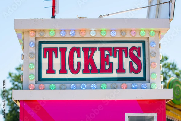 Fototapeta Colorful banner with word Tickets on it on top of the booth.