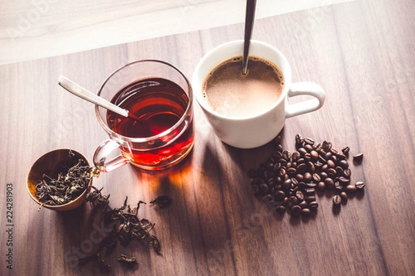 Fototapeta Coffee and tea with coffee bean and tea leaves on wooden floor.