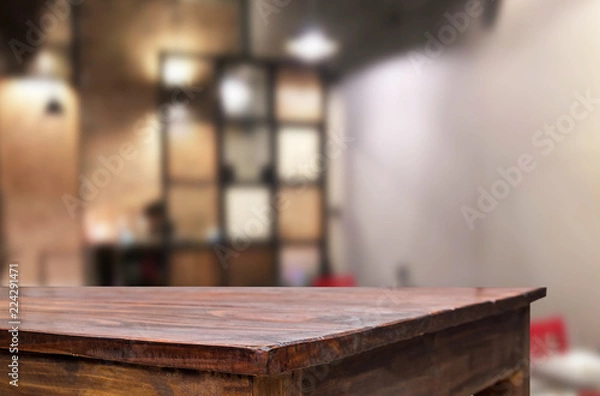 Fototapeta Selected focus empty brown wooden table and Coffee shop or restaurent blur background with bokeh image. for your photomontage or product display