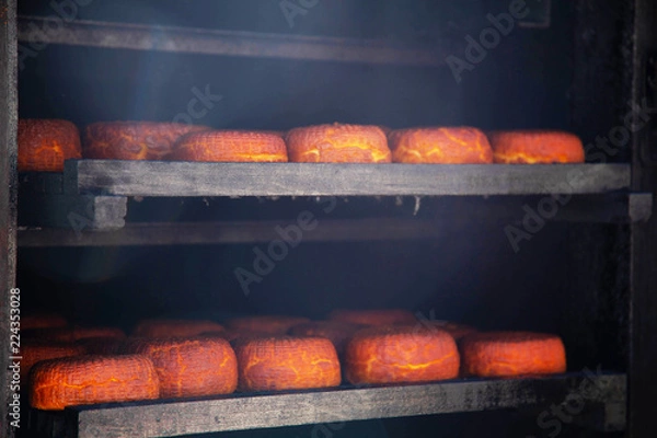 Obraz smoked cheese in the smokehouse