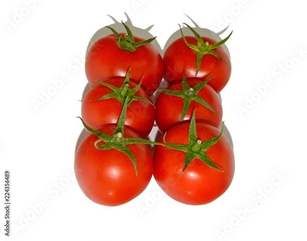 Fototapeta Ripe juicy red tomatoes lie on a white table, natural vitamins
