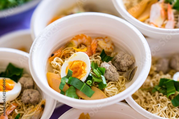 Fototapeta Tom Yum soup is prepared in foam cups. Even though it looks delicious, the harmful substances from the foam mixed in the food is toxic to the body.