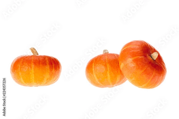 Fototapeta three ripe orange appetizing pumpkins isolated on white