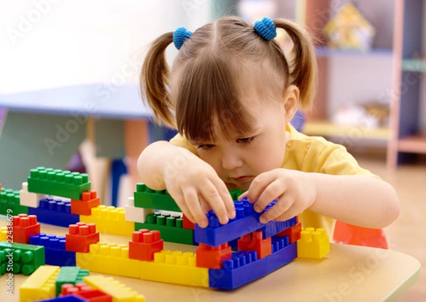 Obraz Little girl play with building bricks in preschool