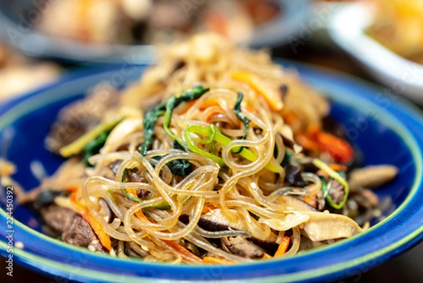 Fototapeta Japchae is a traditional Korean food which is mixed dish of boiled bean threads, stir-fried vegetables, and shredded meat. This dish usually eats every famous Korea thanksgiving holiday called Chuseok