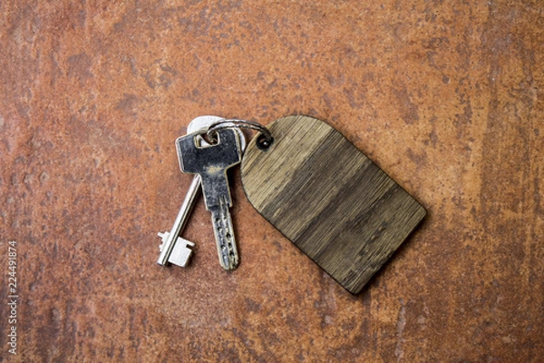Fototapeta Bunch of scrached keys with empty wooden label