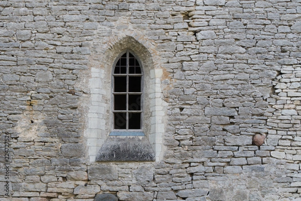 Obraz Window in the stone wall of an ancient monastery destroyed during the Livonian War in the Middle Ages