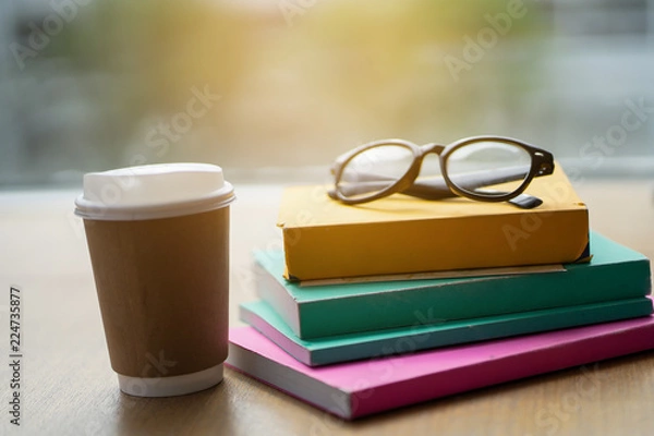 Fototapeta Many books are put on the table with coffee.