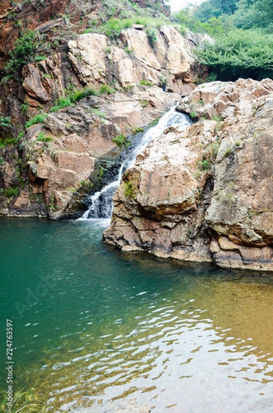 Fototapeta Waterfall into clear dam
