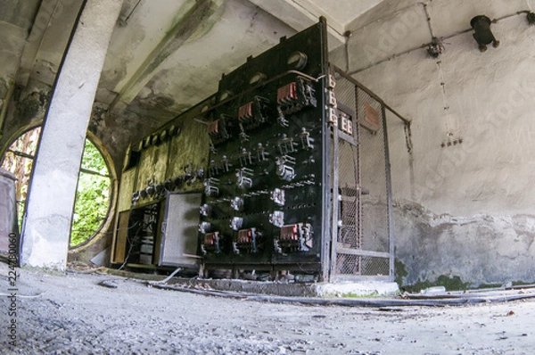 Fototapeta Old damaged fuse cabinet in abandoned building