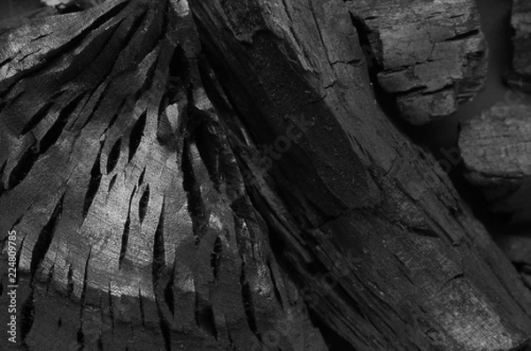 Fototapeta Carbon on an isolated black background, black tones on black texture.