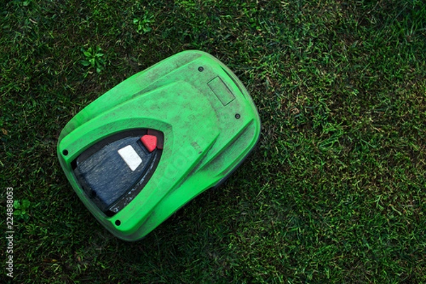 Obraz broken robotic lawnmower with a lot of dust in home garden