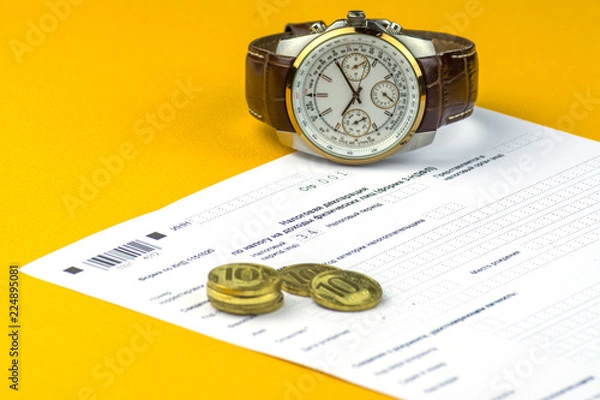 Fototapeta Russian annual tax Declaration of taxes of individuals. The Form 3-NDFL . A few Russian coins and watch are on the sheet of the Declaration.