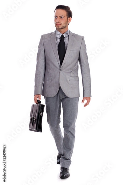 Obraz Businessman carrying briefcase and walking