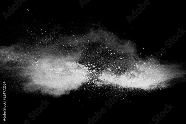Fototapeta Bizarre forms of white powder explosion cloud against black background.White dust particles splash.