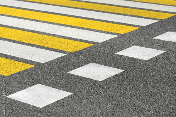 Fototapeta Asphalt road crosswalk with marking lines white and yellow stripes. Road marking pattern.
