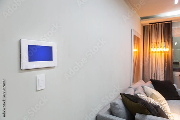 Fototapeta Home interior with a smart home control console or air conditioning setting - remote control
