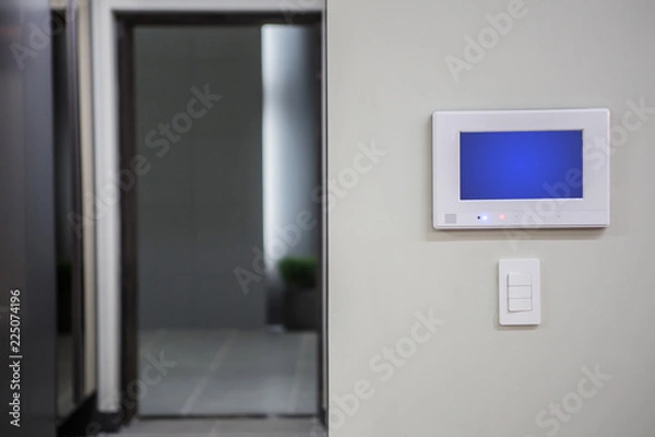Obraz Home interior with a smart home control console or air conditioning setting - remote control touch screen