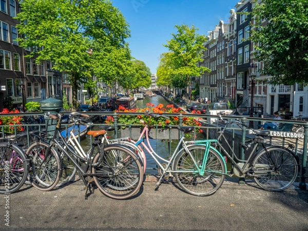 Fototapeta Beautiful view of Amsterdam canals with bridge and bikes. Amsterdam, Netherlands