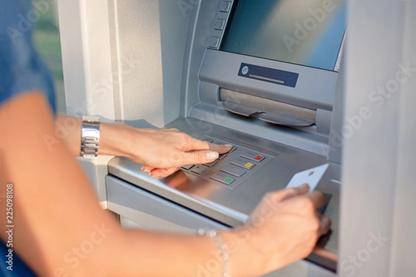 Obraz Close-up Of Person Using Credit Card To Withdrawing Money From ATM Machine