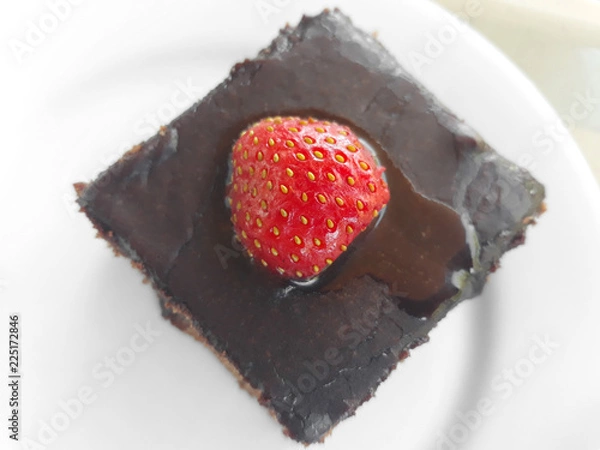 Obraz Chocolate brownie with strawberry on top