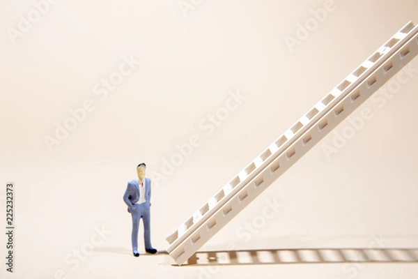 Fototapeta Businessman standing in front of stairs   pointing upwards. Success and development. Setting and achieving goals. Business idea. Increase in profits. the ladder to success.