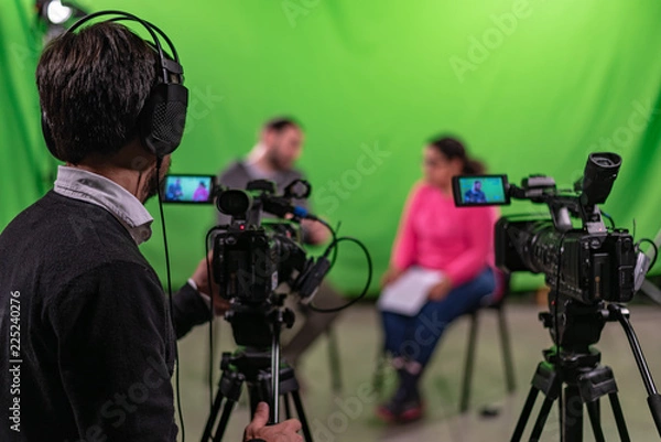 Fototapeta Interview recorded in a chroma with two cameras and one cameraman in frame