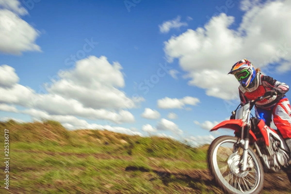Fototapeta woman on enduro motocross in motion, desire for victory, dynamics of speed