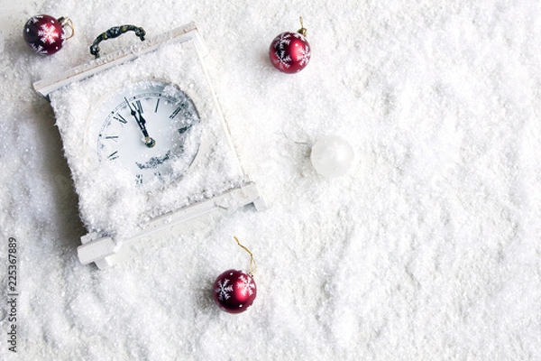Fototapeta Christmas background with clock, snow and Christmas tree decorations.