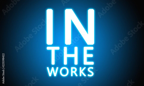 Fototapeta In The Works - glowing white text on blue background