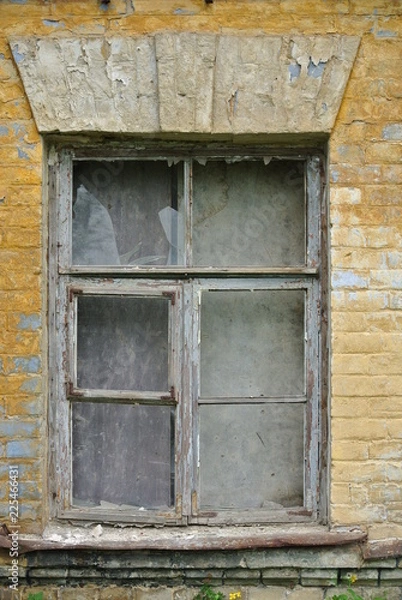 Fototapeta window of an old house with broken glass