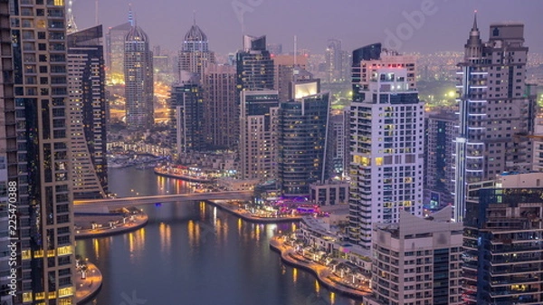 Fototapeta Beautiful aerial top view day to night transition timelapse of Dubai Marina canal