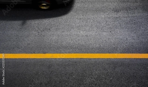 Obraz Yellow paint line on black asphalt. space transportation background