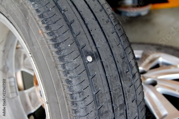 Fototapeta the nut on the tire.It is the cause of tire leakage.Removing the wheel to replace the tire when the problem with the tire leakage, the car can return to work.