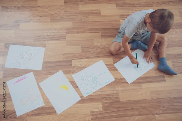 Obraz child does his homework, writes and draws