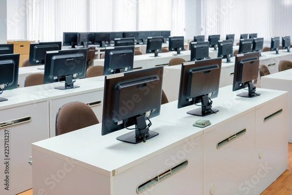 Obraz Classroom computers. Empty no people with many monitor computer on white desk.