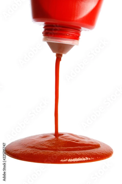 Fototapeta pouring ketchup from bottle on white background